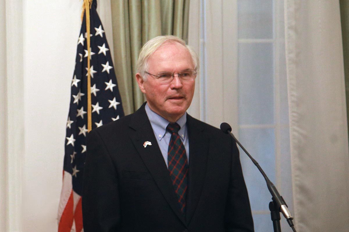 A person standing in front of a microphone

Description automatically generated