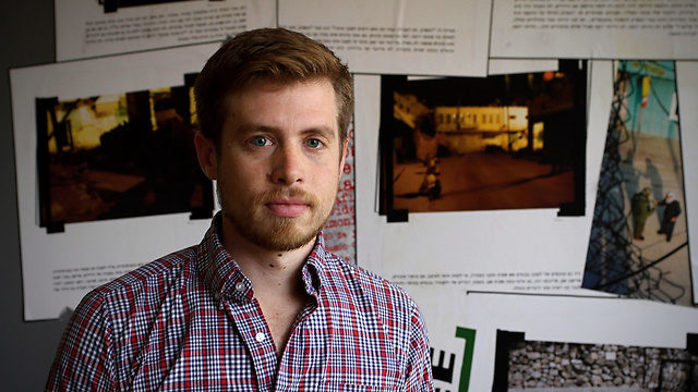 A person standing in front of a wall of pictures

Description automatically generated