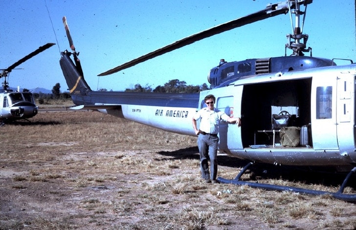 A person standing next to a helicopter Description automatically generated