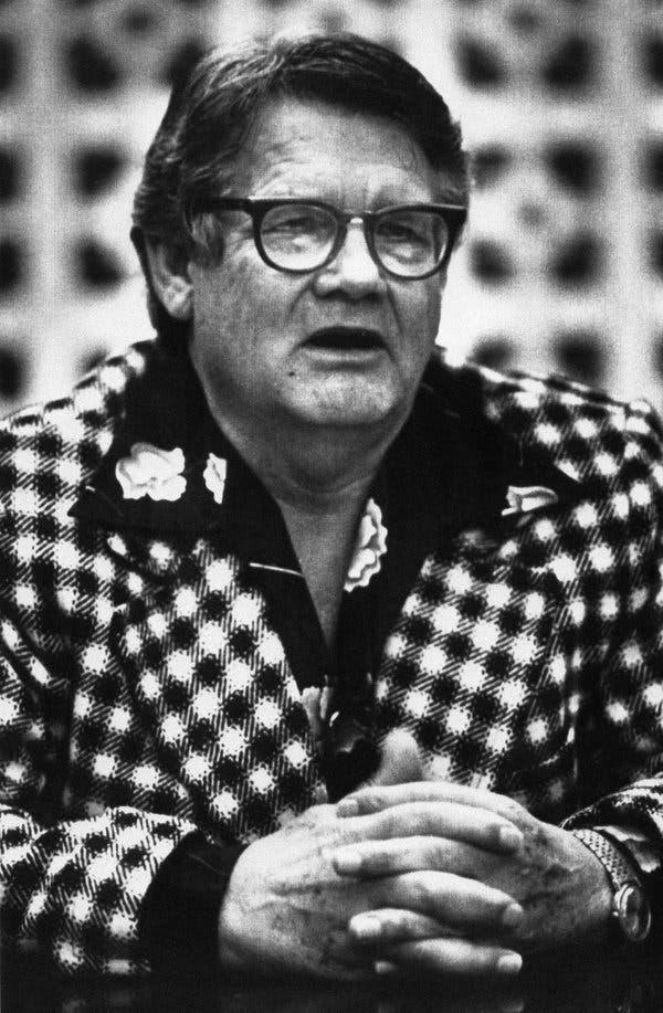 A person wearing glasses and a checkered jacket
Description automatically generated