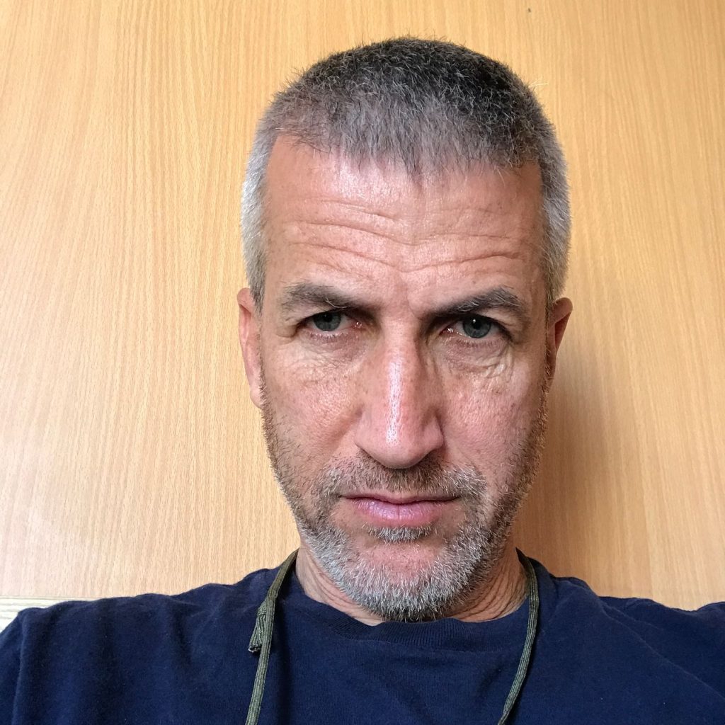 A person with a beard
Description automatically generated