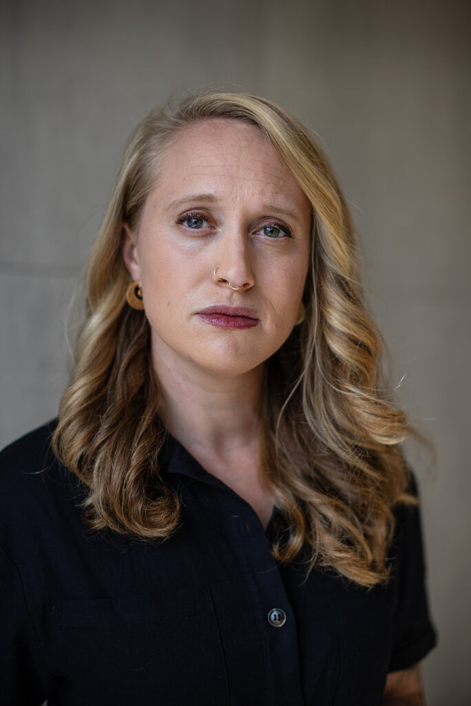 A person with long blonde hair

Description automatically generated