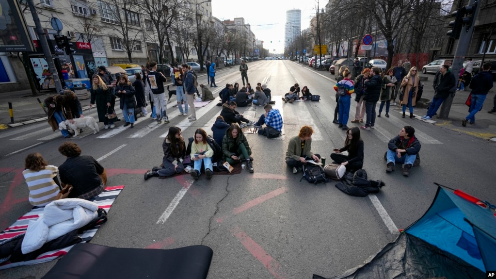 University students sit on a key traffic alley in downtown Belgrade, Serbia, Dec. 29, 2023. A group of university students on Friday launched a 24-hour blockade of the alley as part of protest after reports of irregularities in a recent election. 