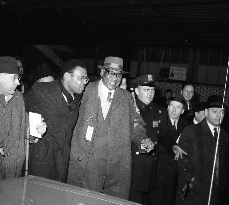 A group of men in a crowd

Description automatically generated