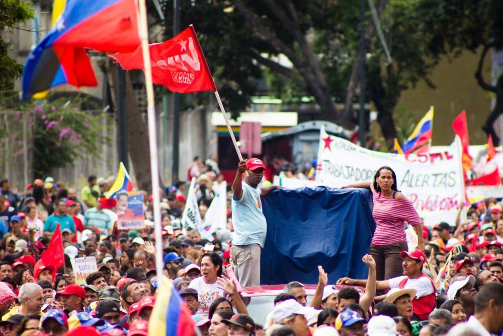 A group of people protesting in a street

Description automatically generated