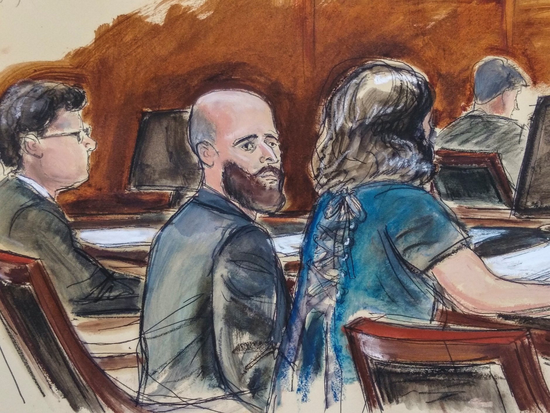 A group of people sitting in a courtroom

Description automatically generated
