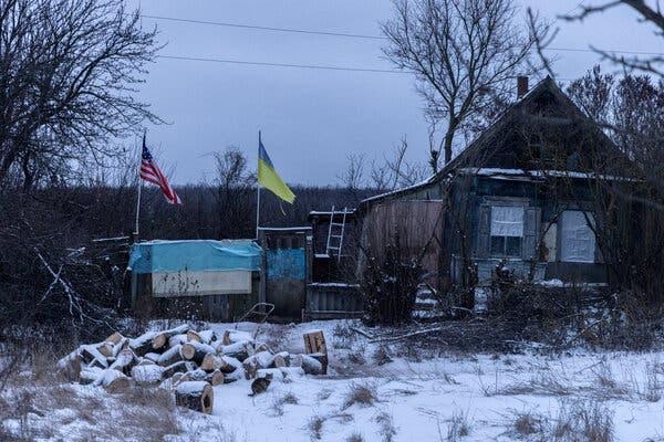 A house with flags in the snow

Description automatically generated