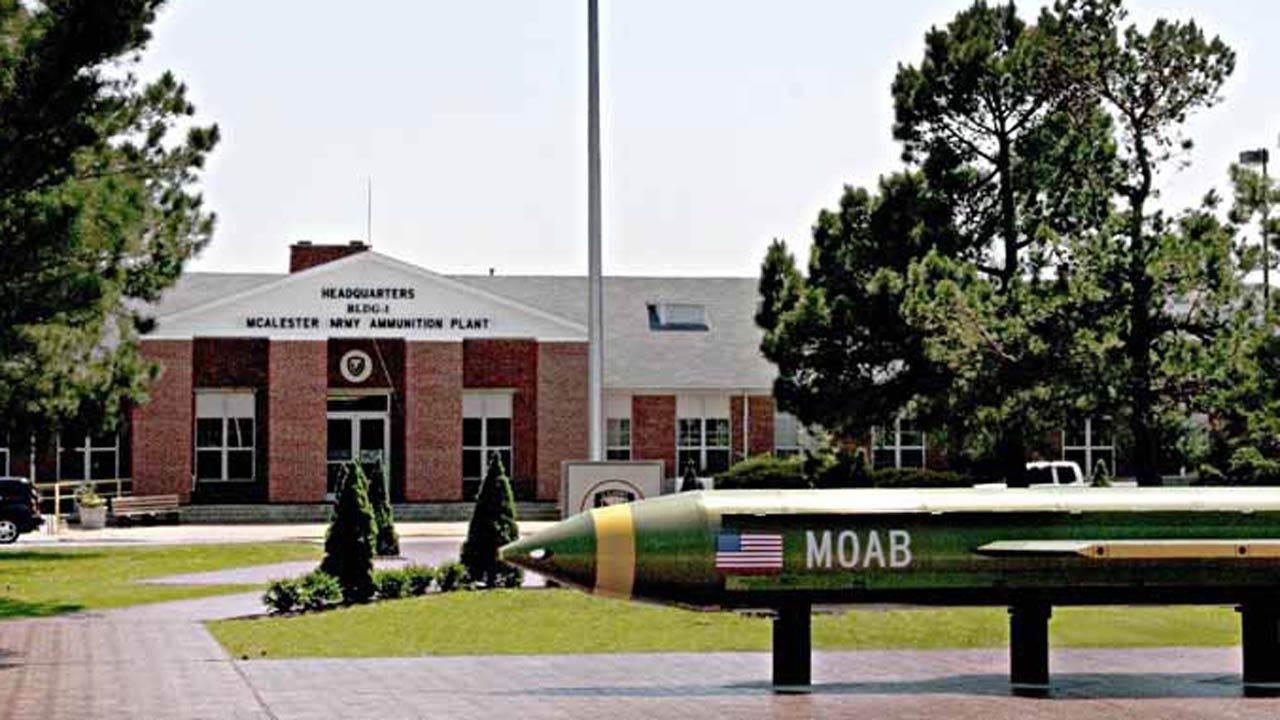 A large missile in front of a building

Description automatically generated