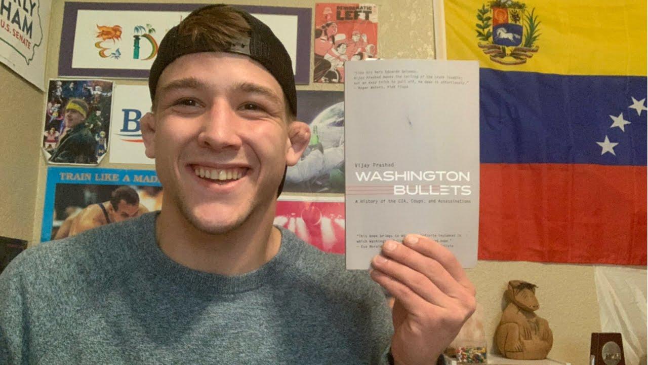 A person holding up a paper

Description automatically generated