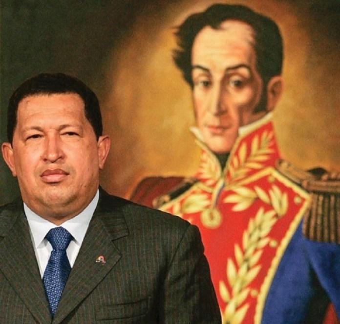 A person in a suit and tie standing in front of a painting of a person

Description automatically generated