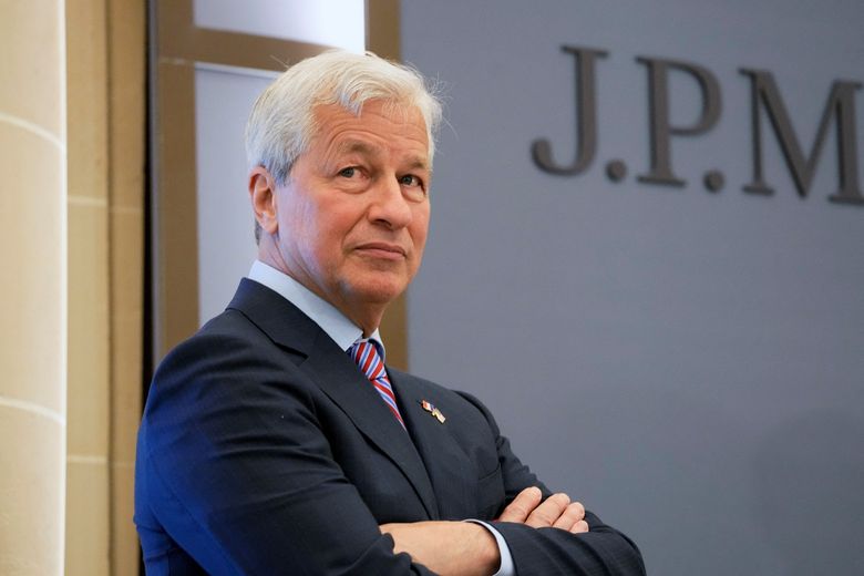 A person in a suit with his arms crossed

Description automatically generated