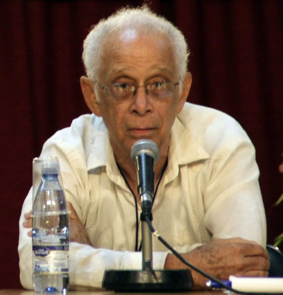 A person sitting at a microphone
Description automatically generated