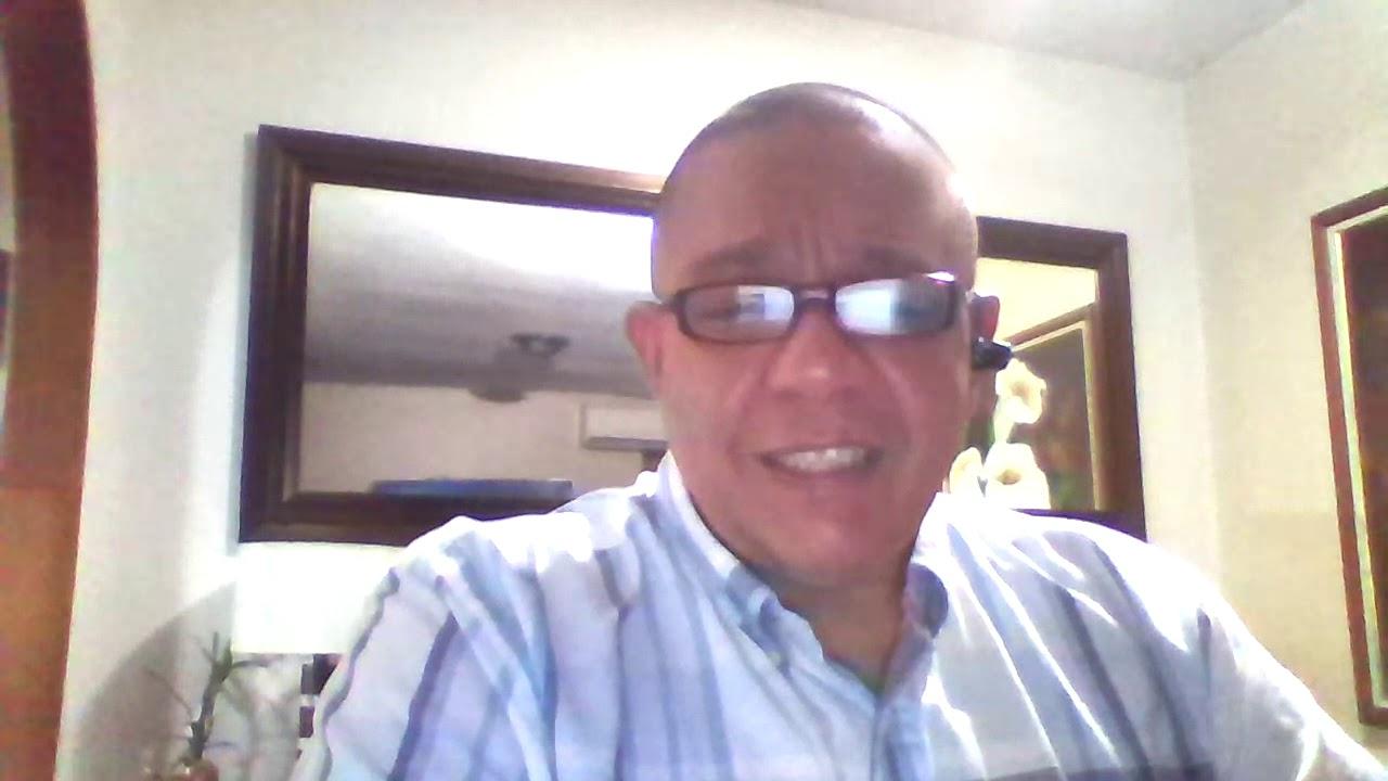 A person wearing glasses and smiling

Description automatically generated