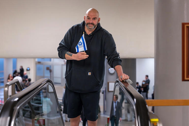 Sen. John Fetterman waves Israeli flag from his roof after pro-Hamas protesters gather outside his Pa. home