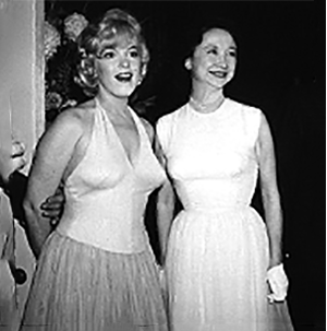 A couple of women in white dresses

Description automatically generated