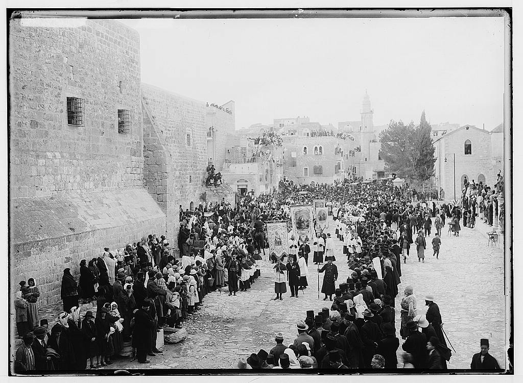 A crowd of people in a street

Description automatically generated