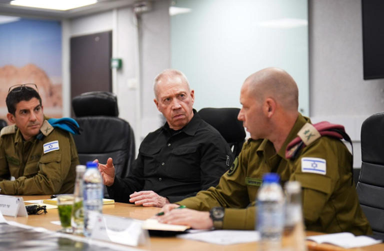A group of men in military uniforms sitting at a table

Description automatically generated