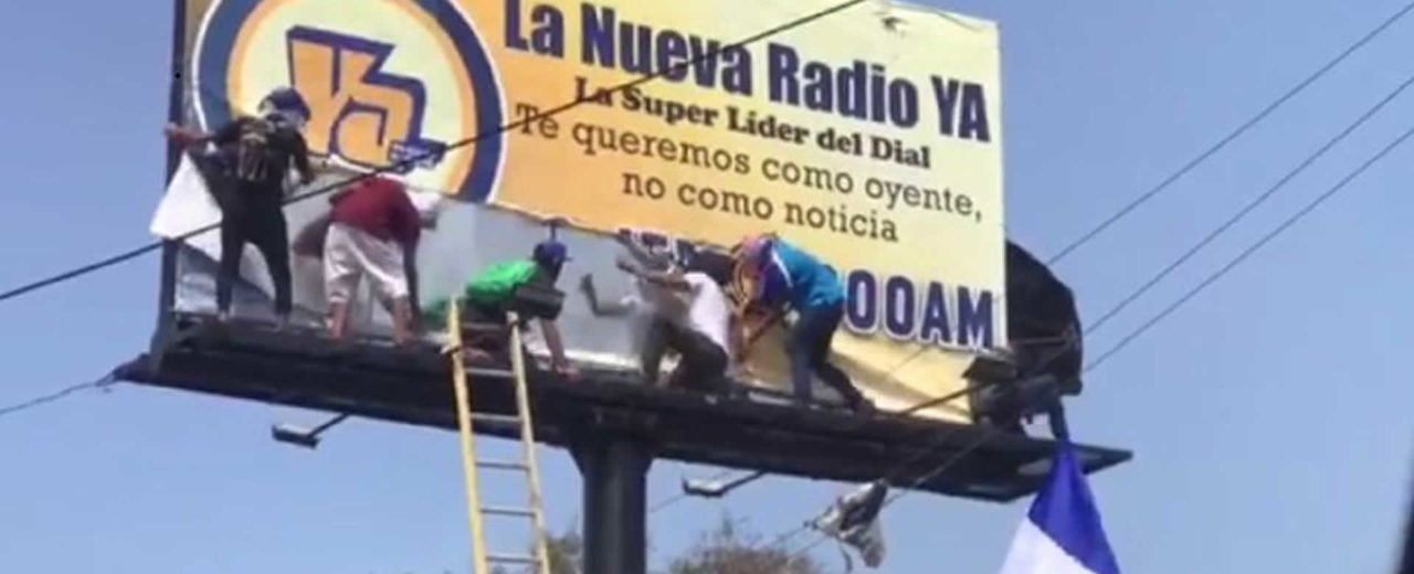 A group of men working on a sign
Description automatically generated