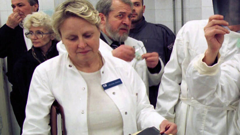 A group of people in white coats

Description automatically generated