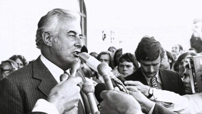 A person speaking into microphones

Description automatically generated