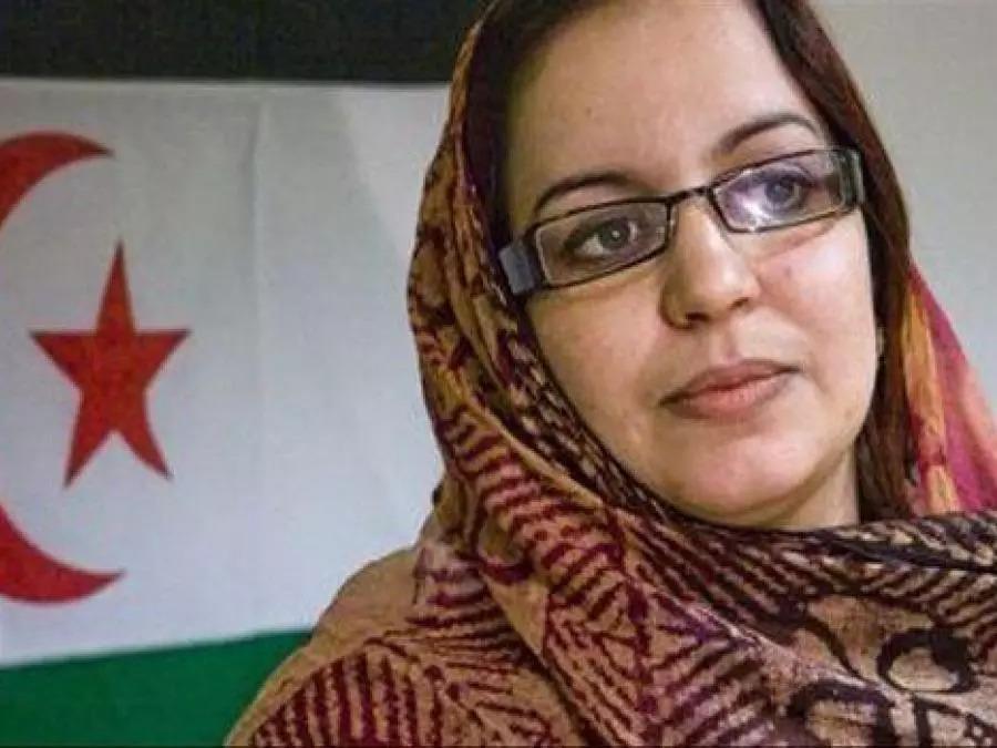 A person wearing glasses and a headscarf

Description automatically generated