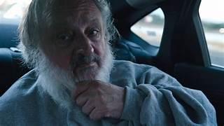 A person with a beard in a car

Description automatically generated