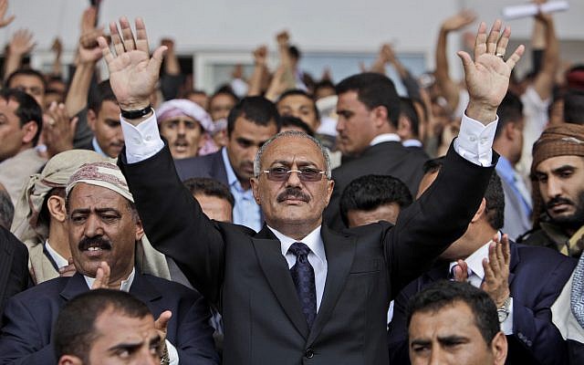 In this April 15, 2011, photo then Yemeni President Ali Abdullah Saleh waves to supporters in Sana'a, Yemen. (AP Photo/Muhammed Muheisen)