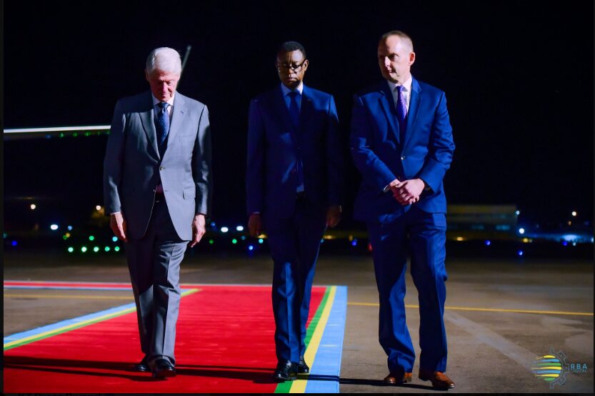 A group of men walking on a red carpet

Description automatically generated