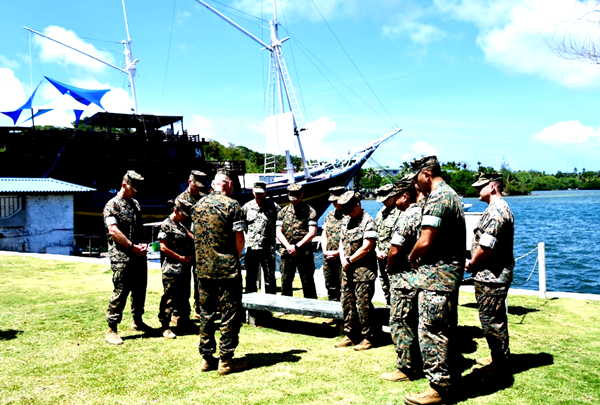 A group of military men standing in a line Description automatically generated