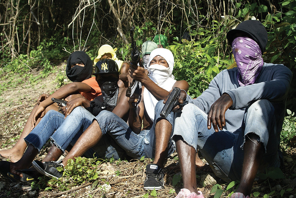 A group of people holding guns

Description automatically generated