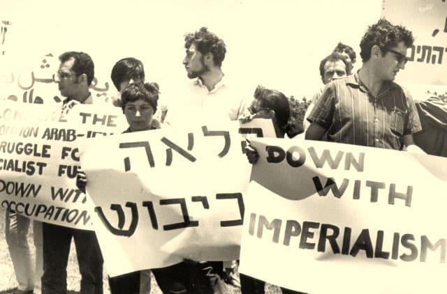 A group of people holding signs

Description automatically generated