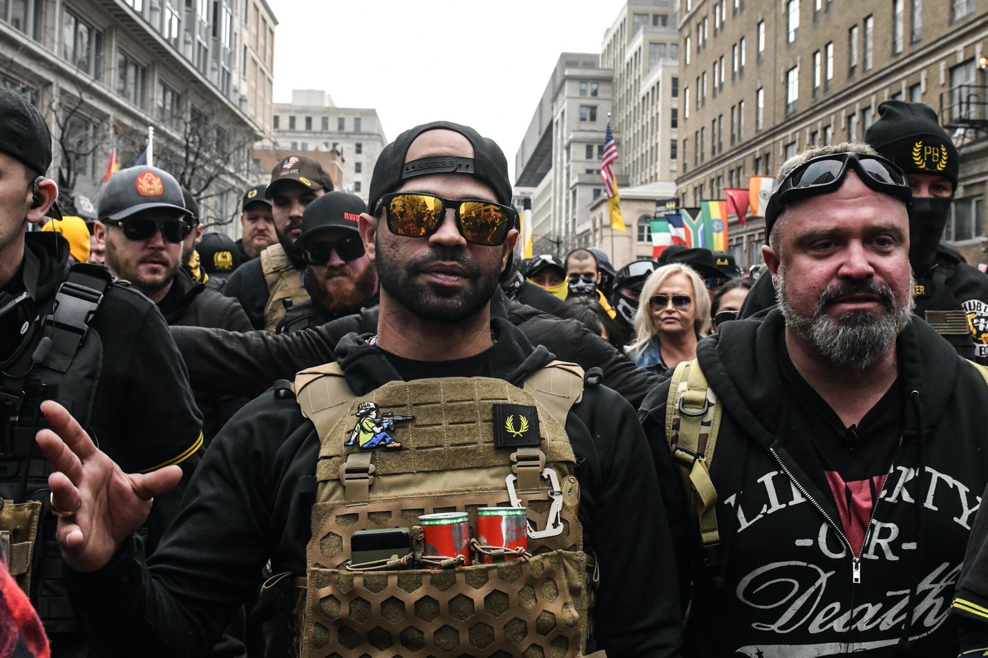A group of people in military vests

Description automatically generated