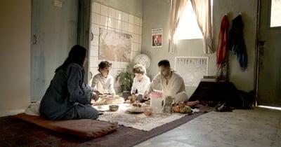 A group of people sitting around a table
Description automatically generated