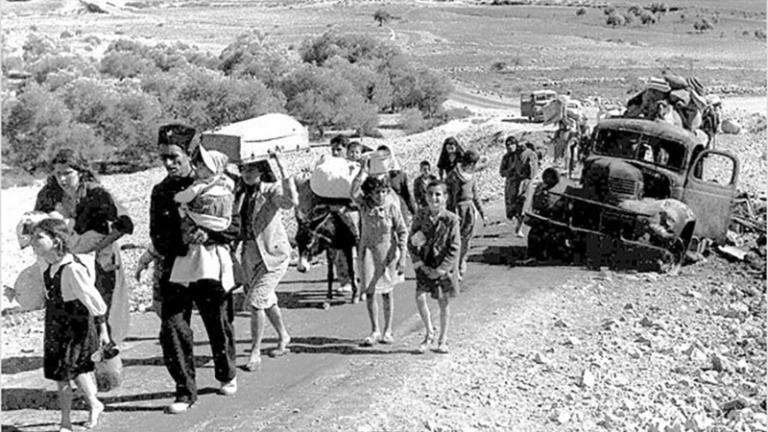 A group of people walking on a road

Description automatically generated