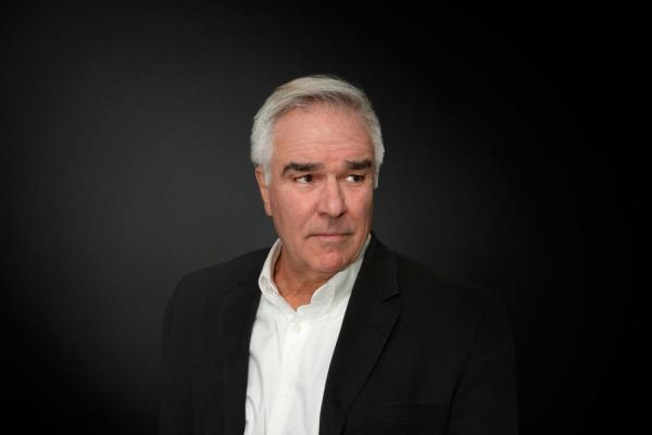A person in a black suit

Description automatically generated