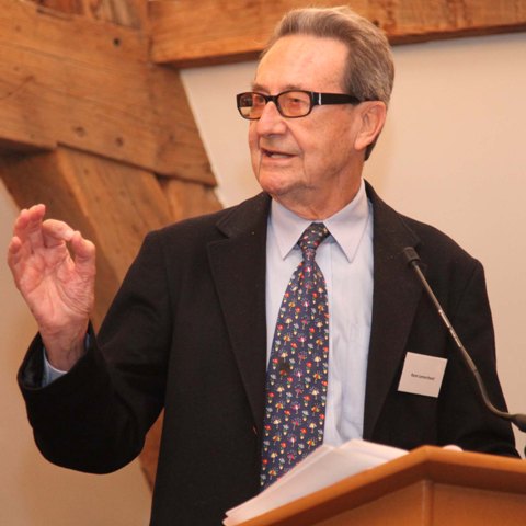 A person standing at a podium

Description automatically generated