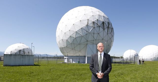 A person standing in front of a white sphere

Description automatically generated