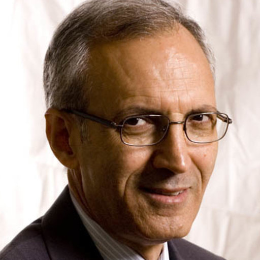 A person wearing glasses and a suit

Description automatically generated