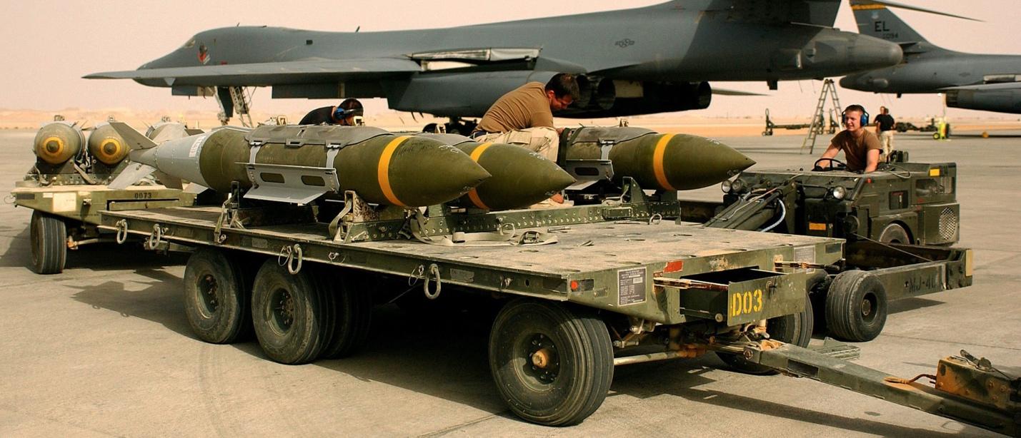 A person working on a military vehicle

Description automatically generated