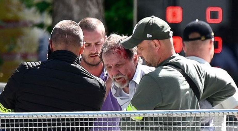 A group of men with a wound on a person's head
Description automatically generated