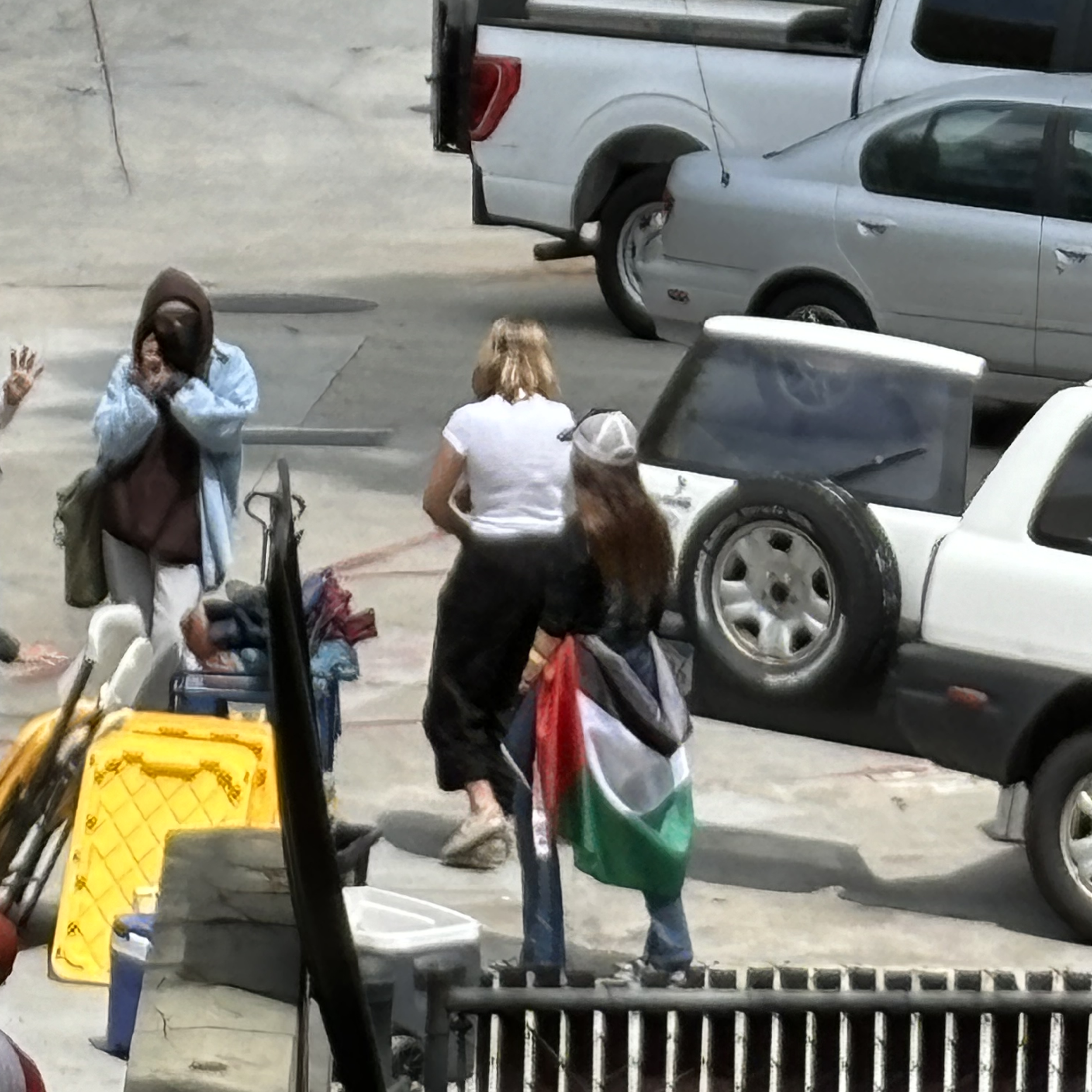 A group of people walking in a parking lot

Description automatically generated