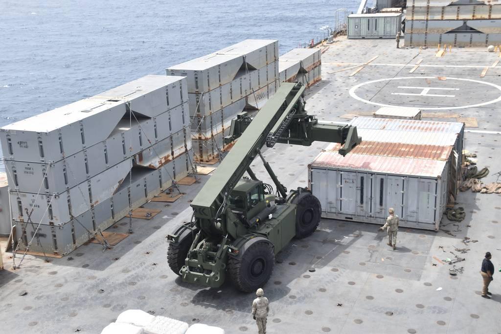 A military vehicle on a ship

Description automatically generated