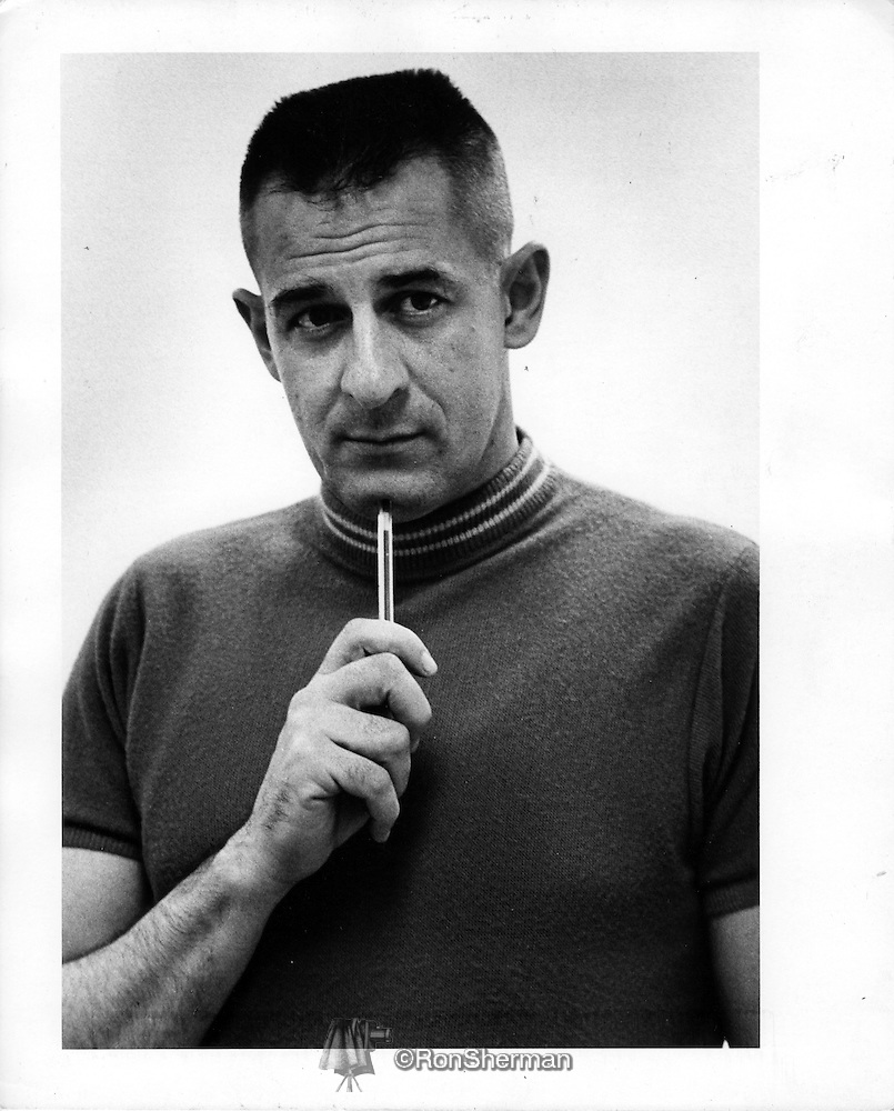 A person holding a pen to his chin

Description automatically generated