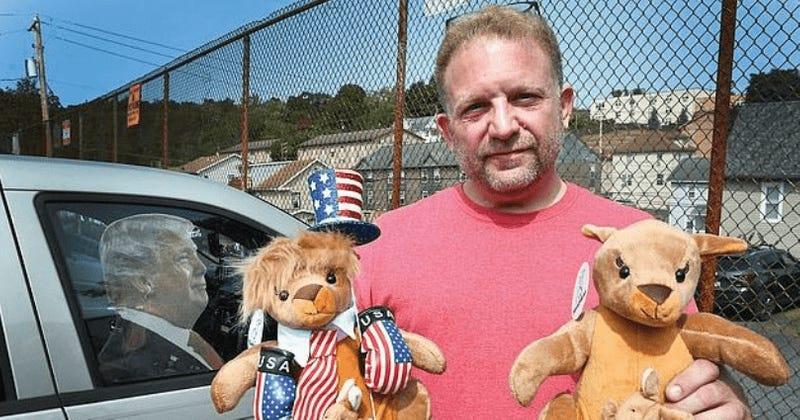 A person holding stuffed animals Description automatically generated