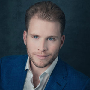 A person in a blue suit

Description automatically generated