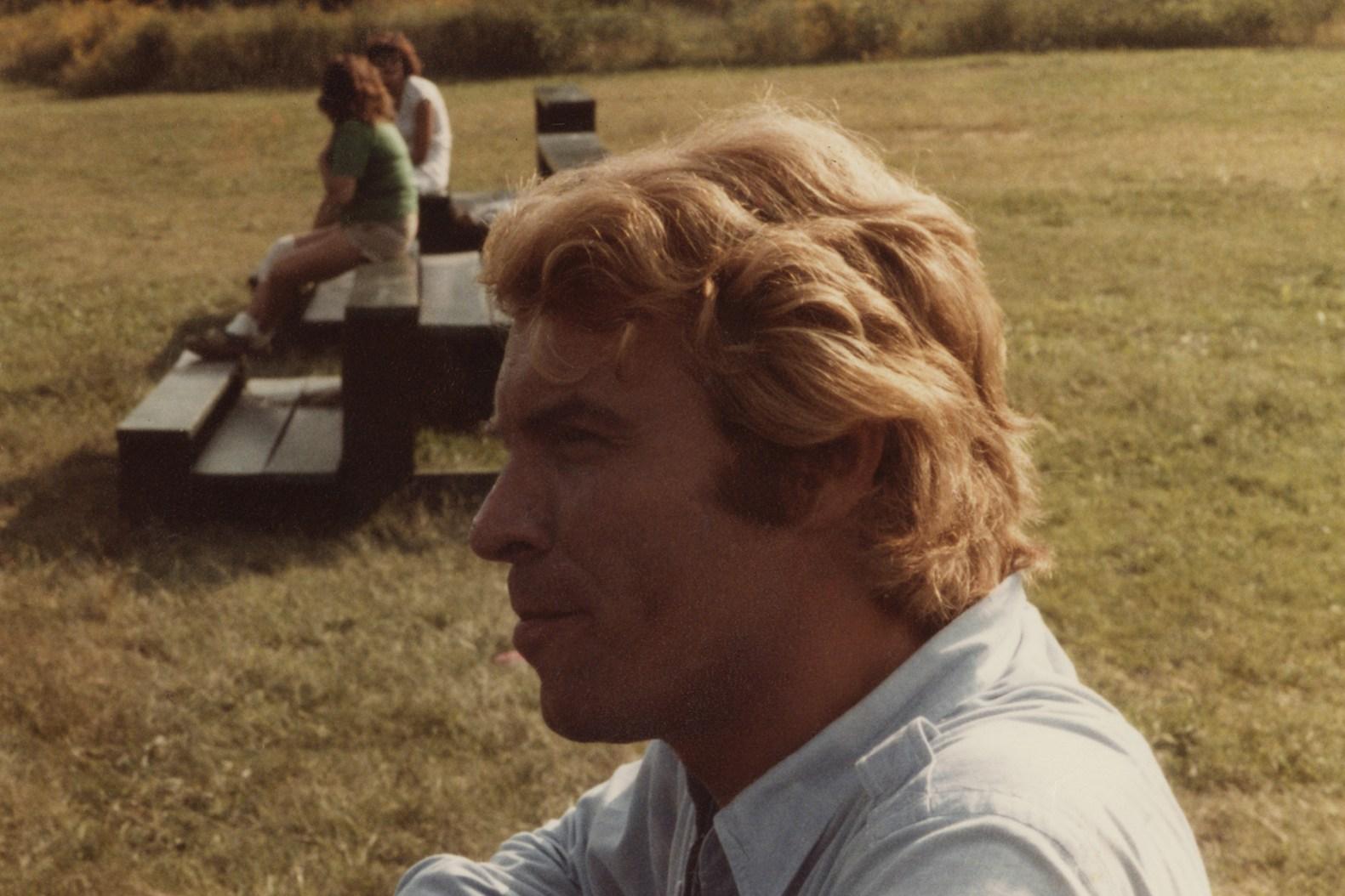 A person sitting on a bench

Description automatically generated