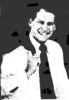 A person smiling and holding his hand up

Description automatically generated
