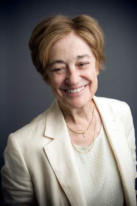 A person smiling at the camera

Description automatically generated