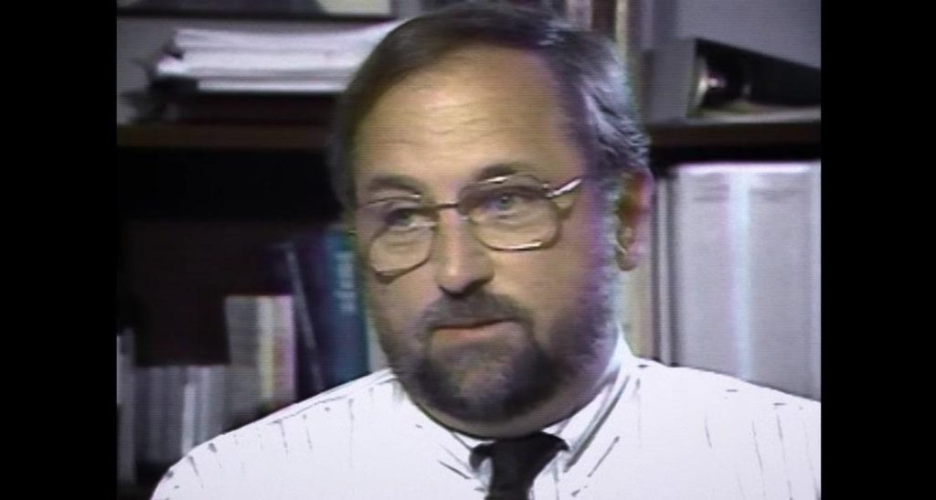 A person wearing glasses and a white shirt

Description automatically generated