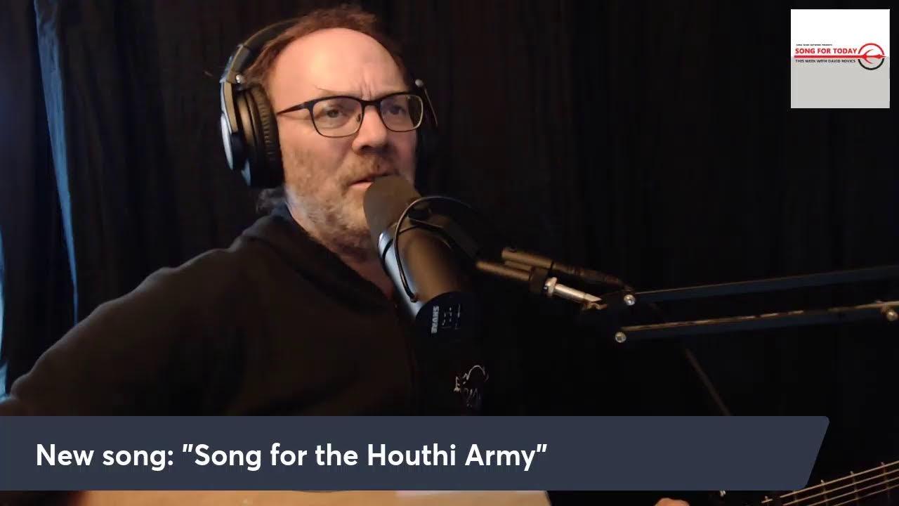 A person wearing headphones and talking into a microphone

Description automatically generated